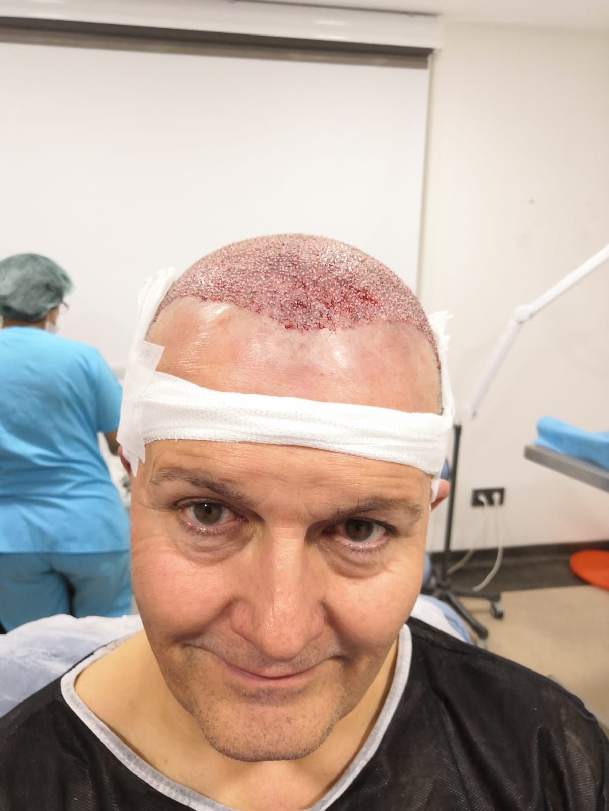 A patient immediately after his procedure with clinical staff behind